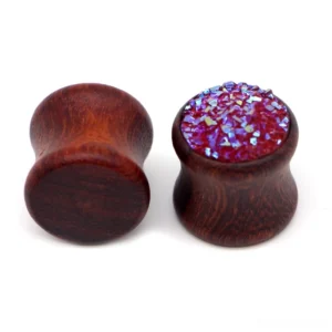 Close-up detail of wine red druzy resin crystal coating on wooden ear gauge flesh tunnel expander