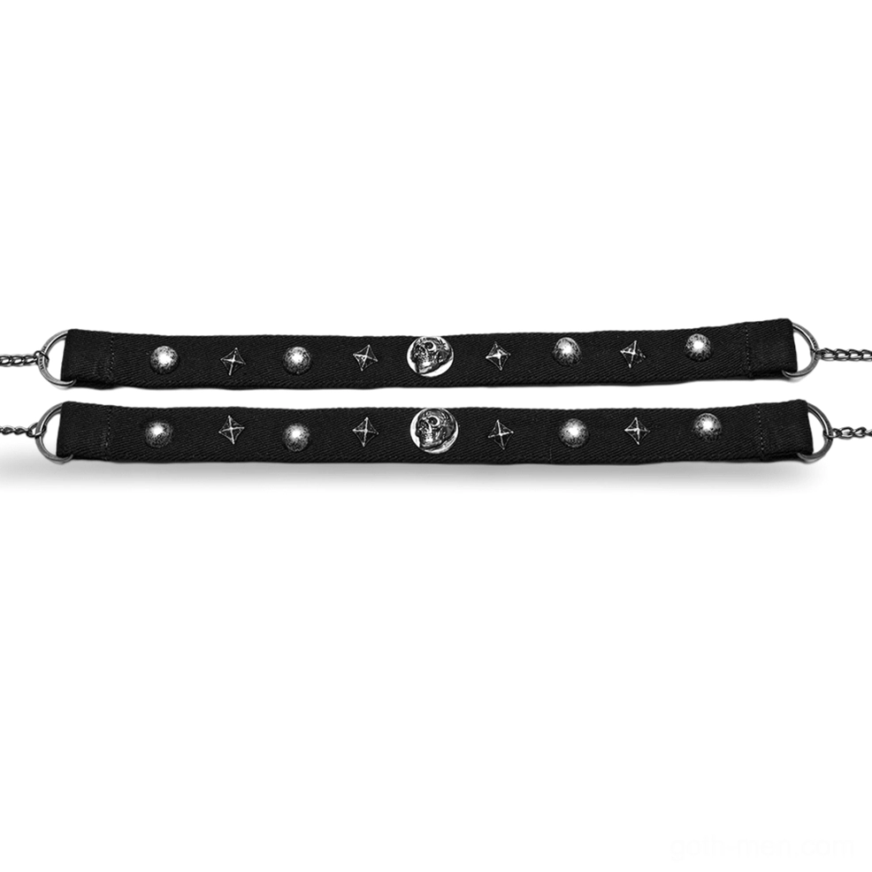 Two black gothic chokers laid flat showing dual-strap configuration with silver ornaments and lobster claw clasps side by side