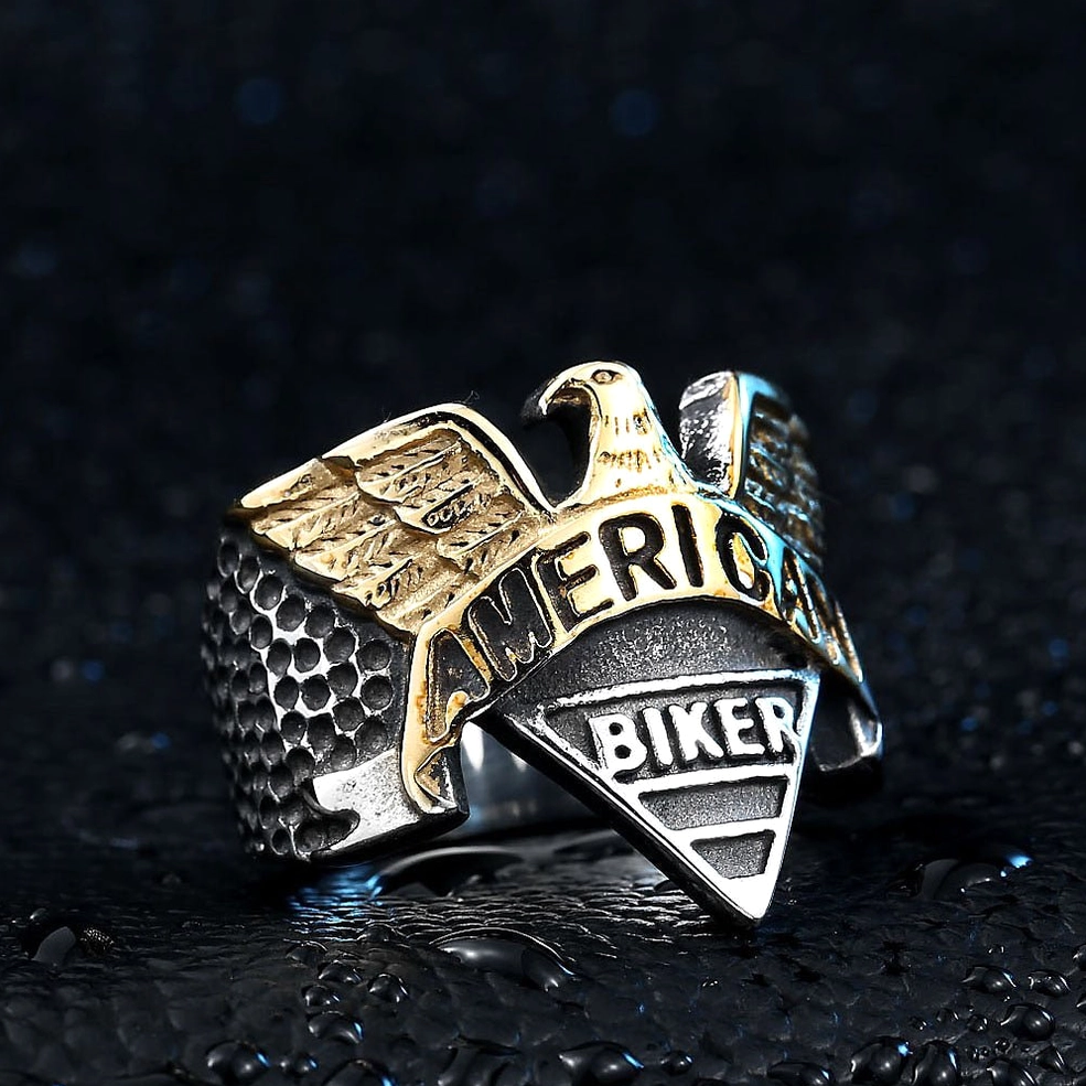 Two-tone gold and silver eagle ring at oblique angle showcasing hammered band and wing engravings