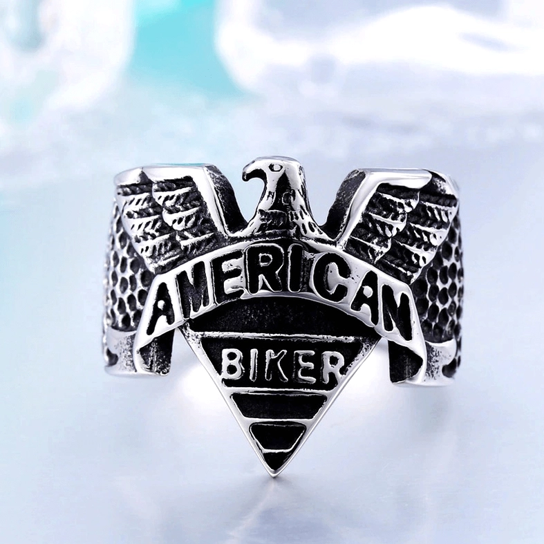 Stainless steel gothic eagle biker ring in two-tone finish with dramatic styling background