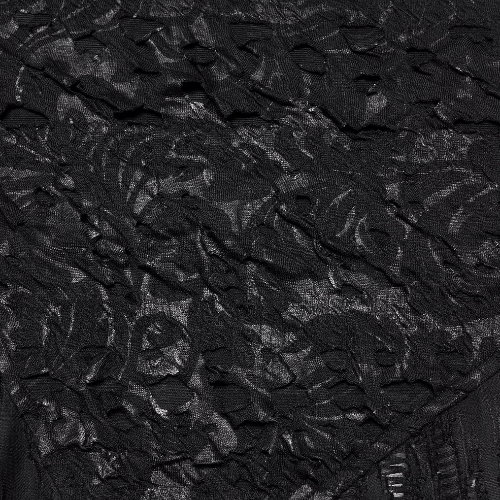 Close-up of black mesh gothic T-shirt embroidered floral panel with 3D embossed textile texture on base fabric