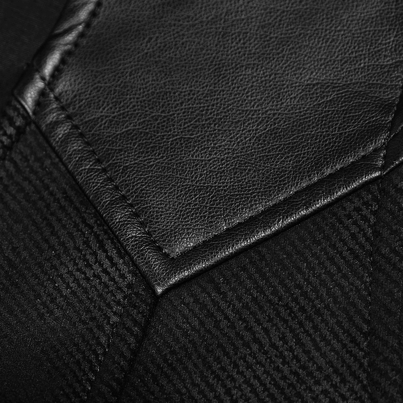 Close-up detail of matte faux leather stitching trim on black woven gothic waistcoat