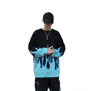 Male model wearing black and cyan flame gothic sweater with black cap silver necklace streetwear style