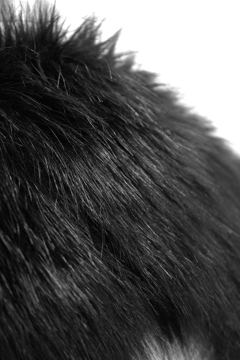 Close-up macro of black fur texture showing dense fluffy pile and material quality