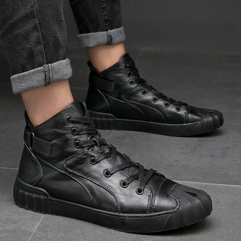 Detailed close-up of genuine leather construction and stitching on black high-top gothic sneaker