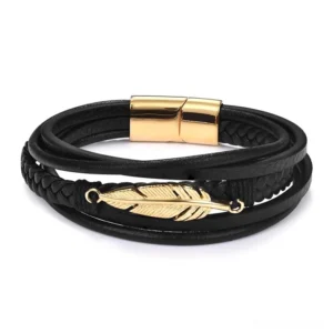 Gold-tone feather charm leather bracelet in dark gothic style with antique gold stainless steel hardware, overhead shot