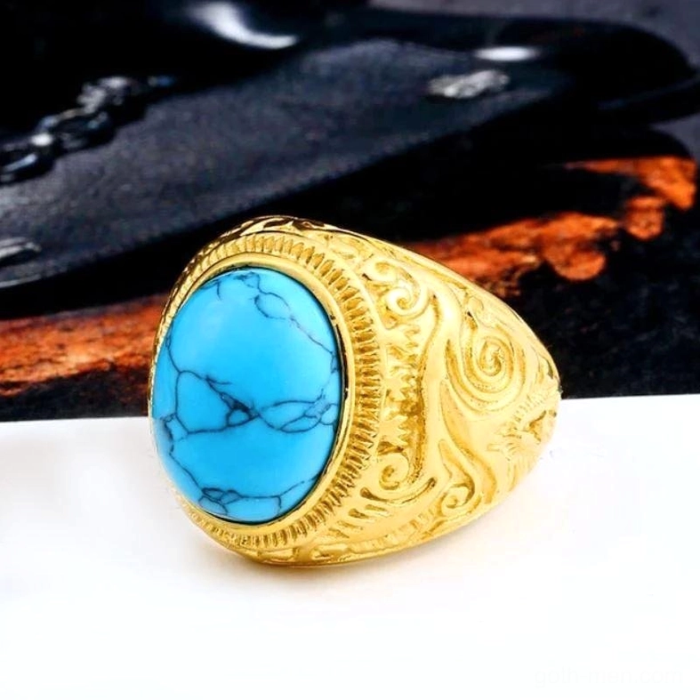 Gold finish gothic bezel ring with turquoise stone, embossed scroll patterns, unisex design