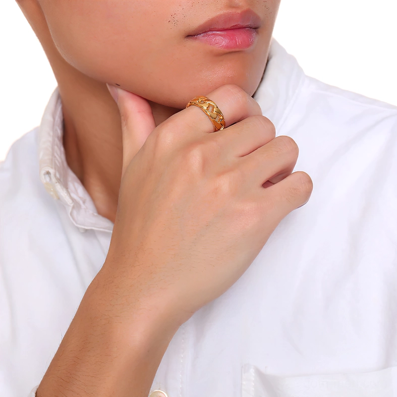 Gold gothic chain ring on finger, studio portrait showing metal finish and chain pattern when worn