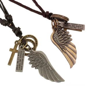 Brown leather gothic angel wing necklace multi-charm pendant set displaying silver and bronze metal winged cross symbols from oblique angle