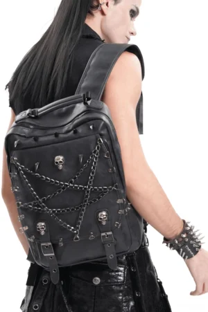 Male goth model wearing pentagram chain skull spike gothic backpack in black leather, rear view studio shot