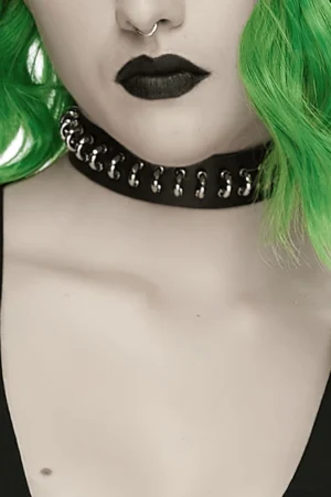 Half-body model shot showcasing black leather gothic choker with silver D-ring studs and snap closure styling