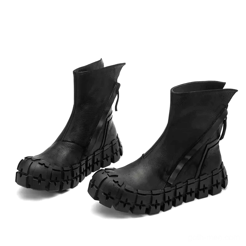 Low-angle three-quarter view of black goth leather ankle boots with matte finish and heavy-duty tread sole