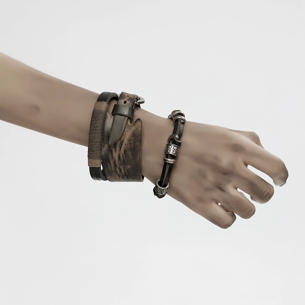 Side view of distressed leather and metal gothic bracelets on female wrist, two complementary bracelet styles, alternative fashion accessory close-up