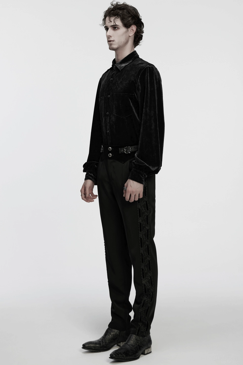 Product photography detail shot of black goth pants leg and lace side seam