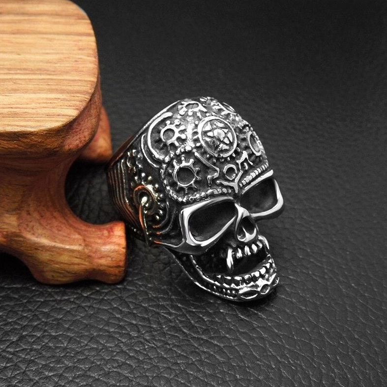 Alternative goth skull ring right side low angle exposing sharp fangs and top gear engraving stainless steel