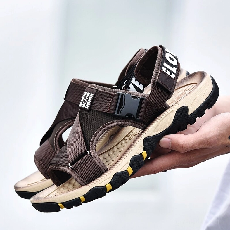 Industrial gothic sandals with metal buckle emphasis and cross strap configuration detail