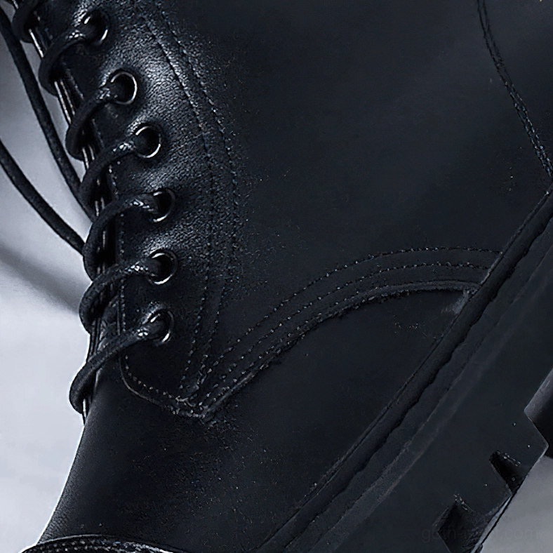 Front close-up of black gothic boot vamp showing stitched seams and metal eyelets