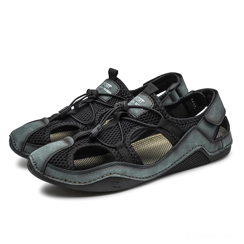 Men's gothic dark teal and black ankle-wrap sandals pair with toggle lace closure front view