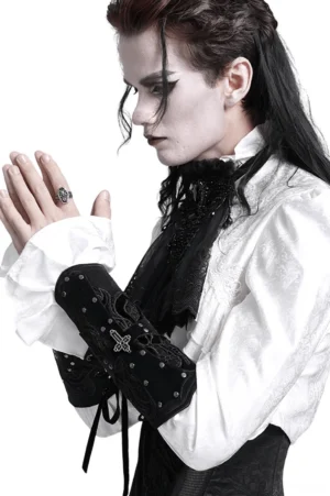 Male gothic performer wearing black lace-up arm guard with cross rivets and metal eyelets, side profile studio view