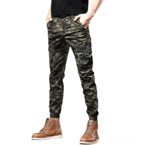 Dark green camouflage slim-fit cargo pants worn by male model in full-body front view showing multi-pocket design and tapered silhouette
