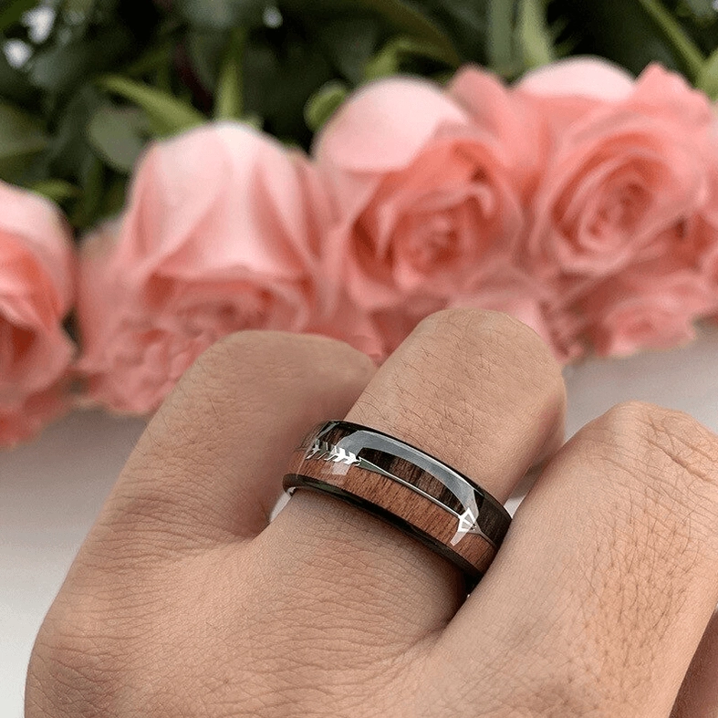 Worn gothic arrow ring on male hand close-up dual-tone alternative jewelry styling