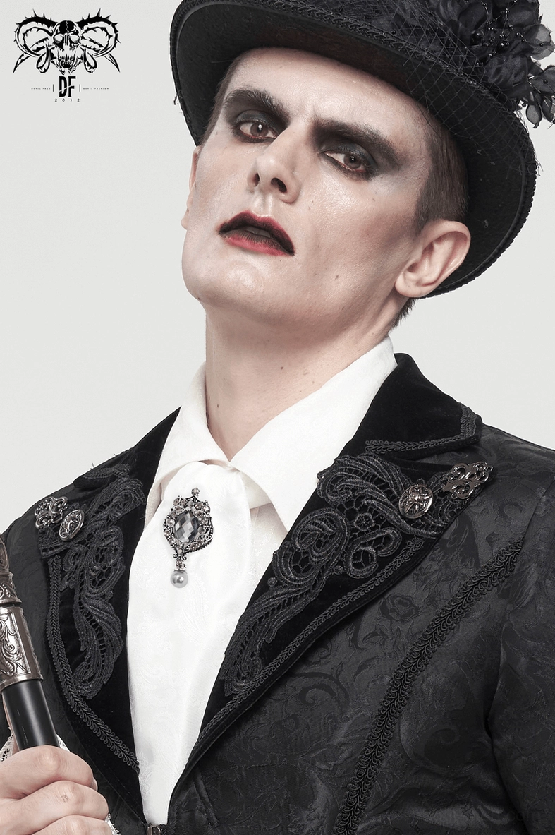 Close-up goth fashion portrait with white ascot tie and ornate crystal brooch detail