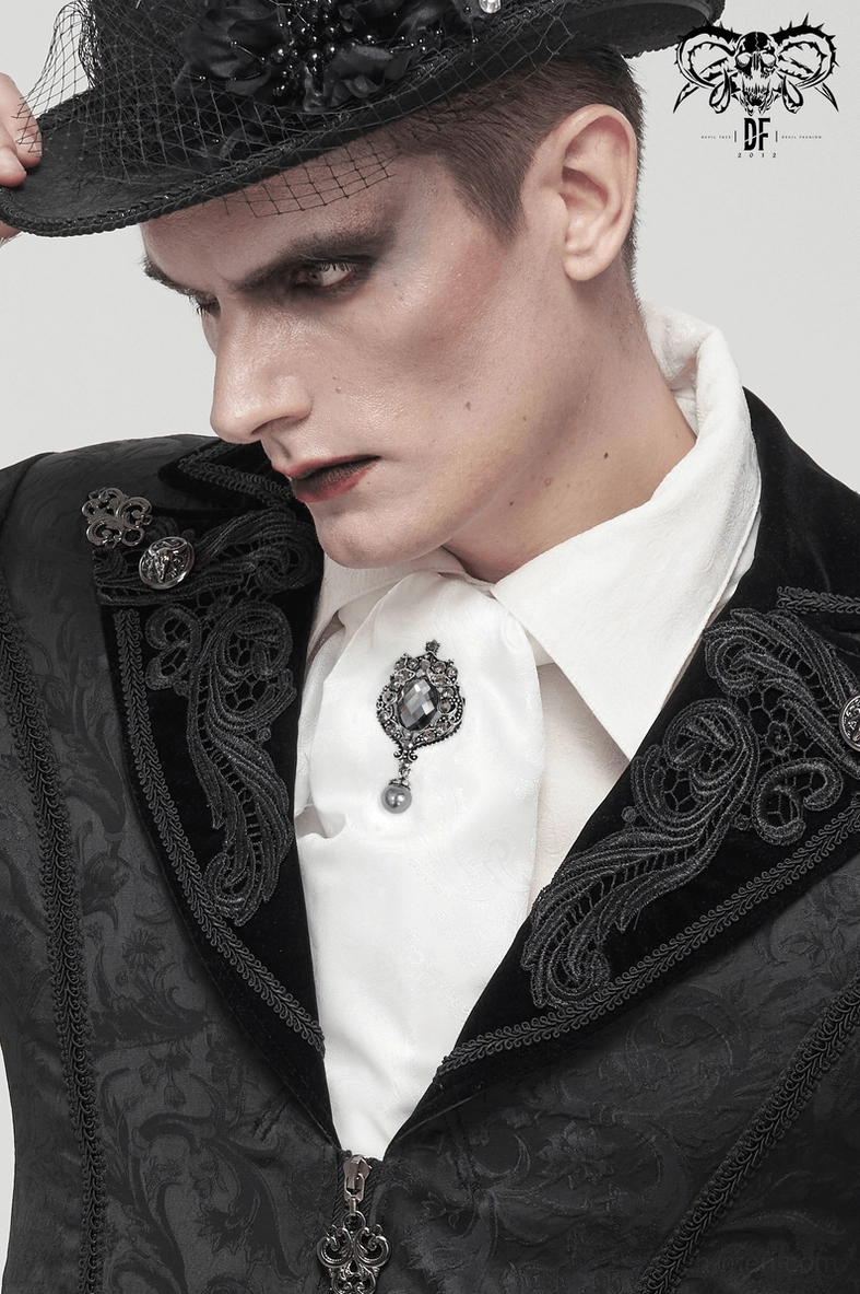 Side profile goth performer showcasing white ascot tie with black formal suit and hat