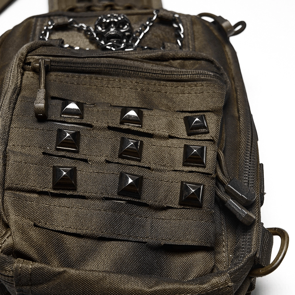 Side close-up view of gothic backpack front pocket with pyramid stud decorations and tactical webbing details