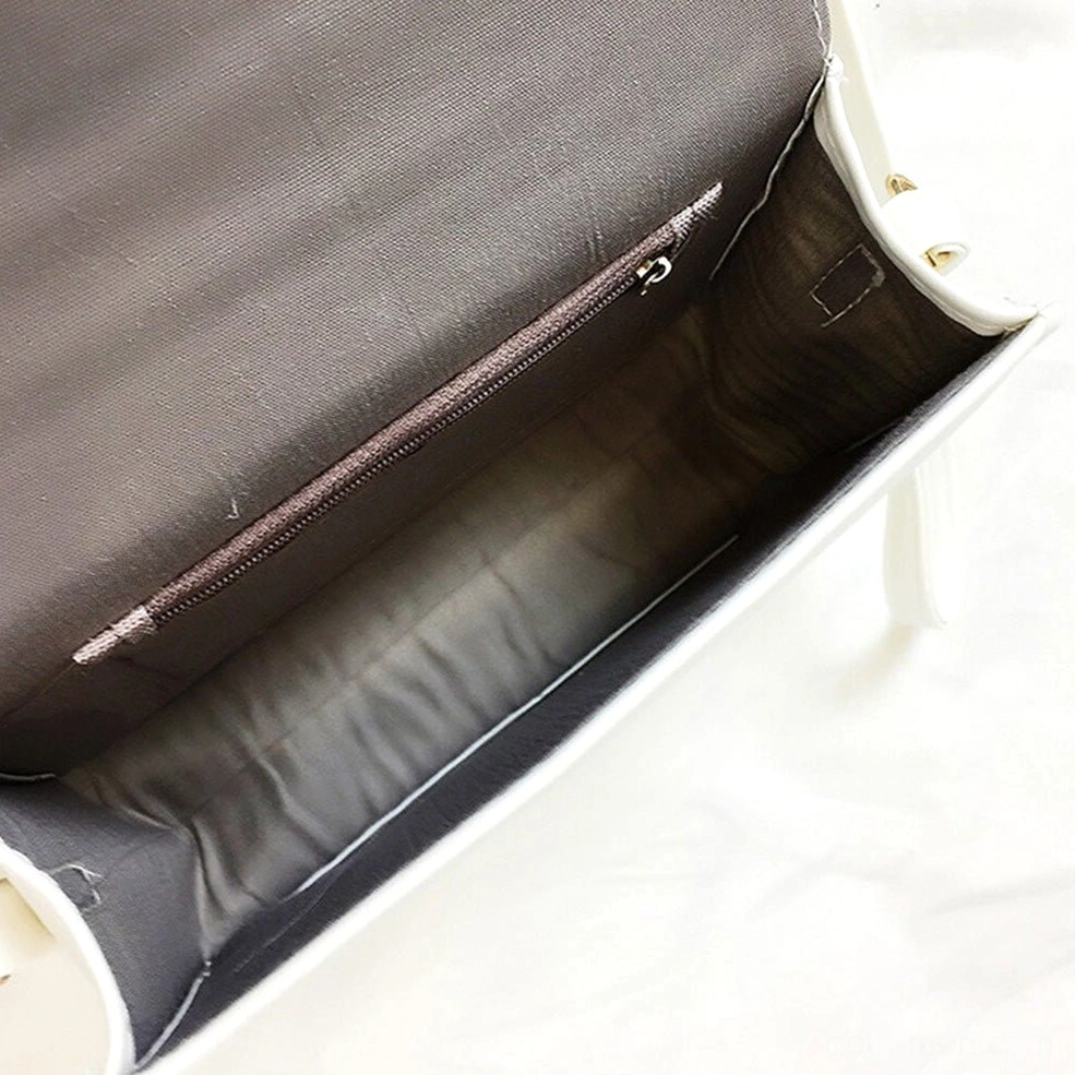 Interior of gothic crossbody bag showing gray fabric lining and internal zipper pocket