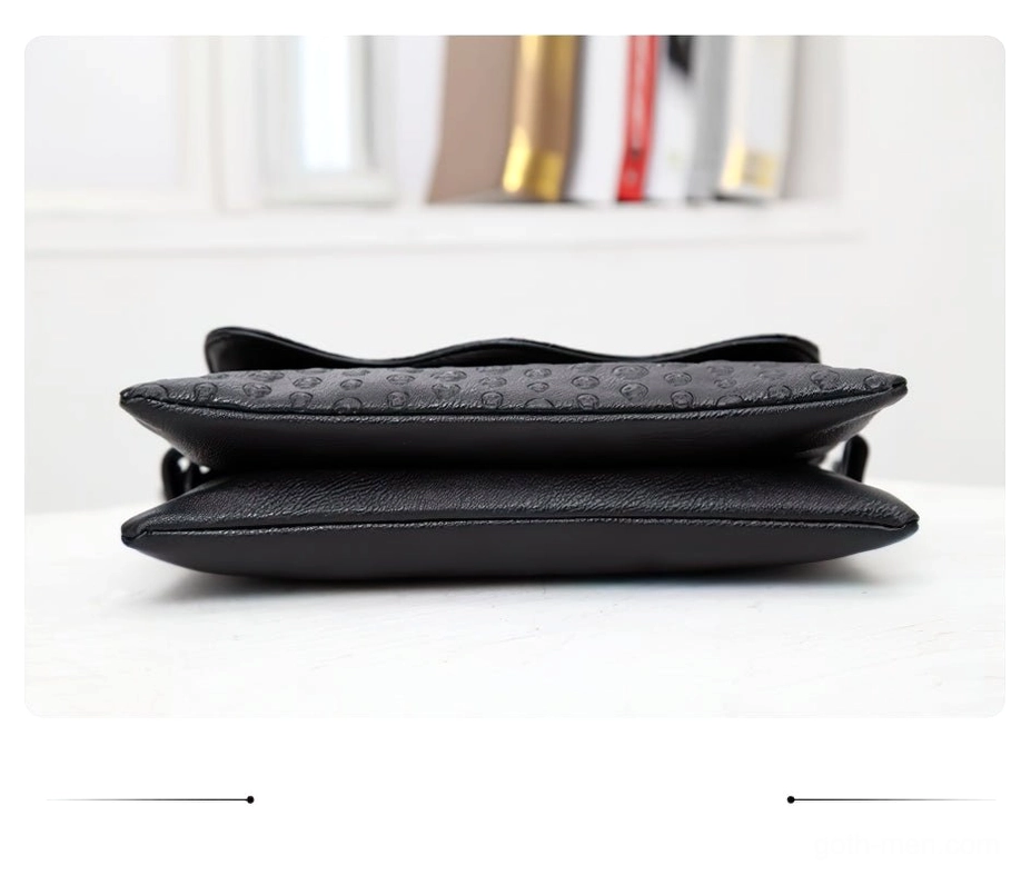 Side flat lay perspective of black leather gothic handbag displaying embossed details and layered silhouette
