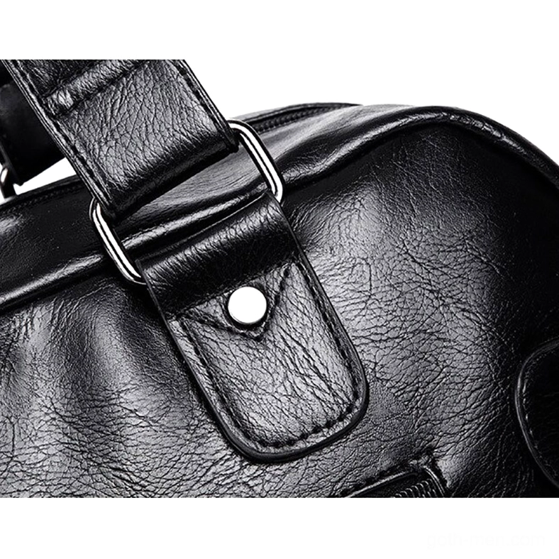 Close-up detail of leather messenger bag strap with silver metal buckle and decorative snap button