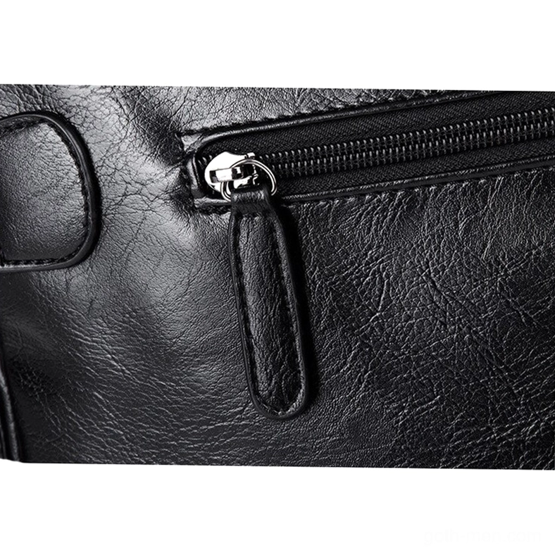 Close-up of gothic leather bag zipper detail with silver metal puller and stitched leather trim