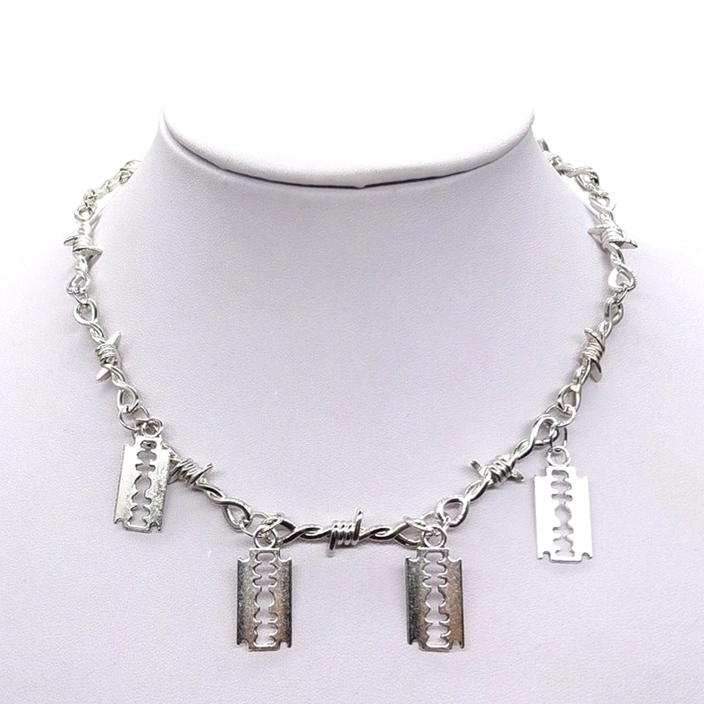 Silver gothic barbed wire choker with razor blade pendants displayed on neck mannequin - front view showing link chain construction and sharp pendant design