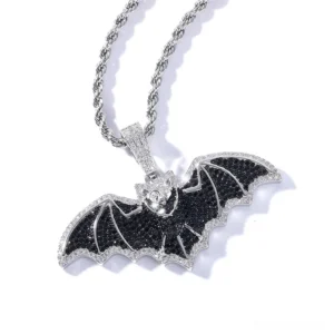 Gothic black cubic zirconia bat pendant necklace with silver finish and pavé stone wing details, overhead view showing intricate gem setting