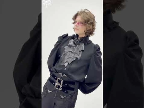 Gothic vampire outfit styling guide, showing bat wing blouse paired with wide waist belt and patterned trousers for complete alternative fashion ensemble