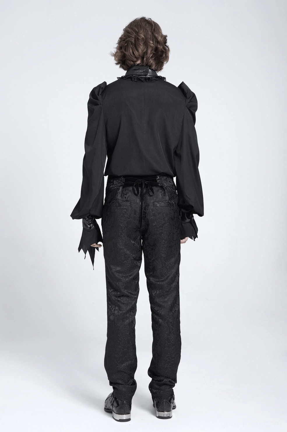 Black gothic bat wing blouse rear back view of model wearing complete ensemble with ruffled collar and structured shoulder architecture visible