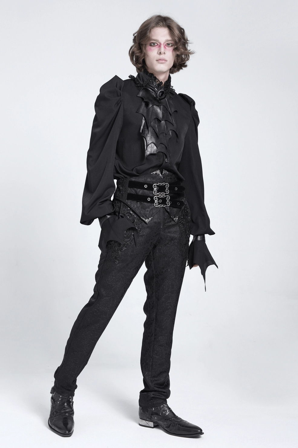 Gothic bat wing blouse detail showing theatrical ruched sleeve construction, faux leather accent work, and dimensional design elements in black