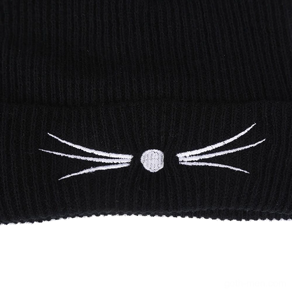 Embroidery detail close-up of white stitched whiskers and round nose on black gothic cat beanie ribbed knit