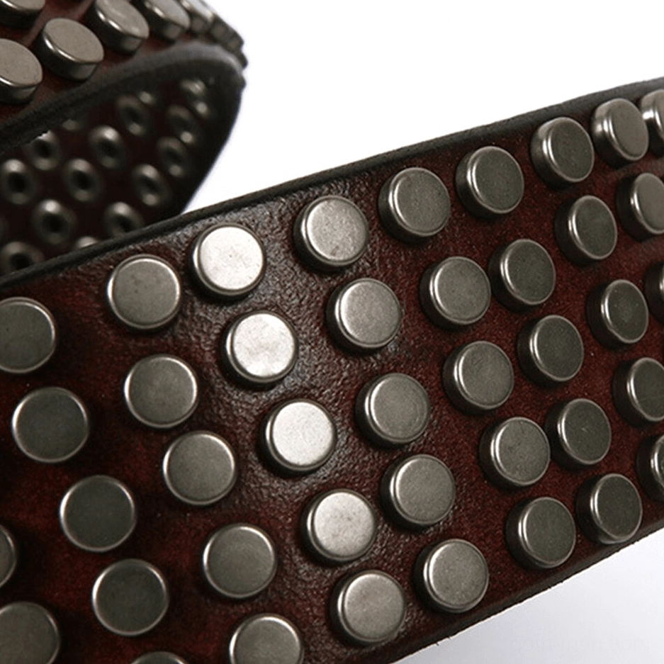 Macro close-up of round metal rivets on dark brown leather showing texture and spacing