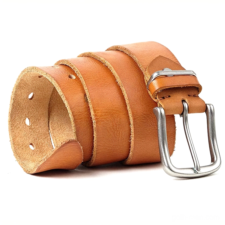 Tan coffee-colored leather gothic belt stacked in rolled loops with silver pin buckle detail visible