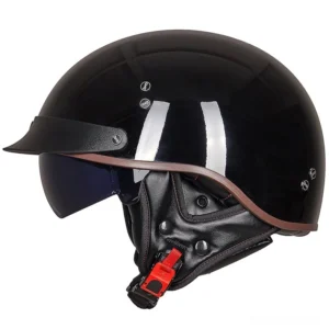 Black gothic half-face biker helmet front three-quarter view with integrated UV protection visor