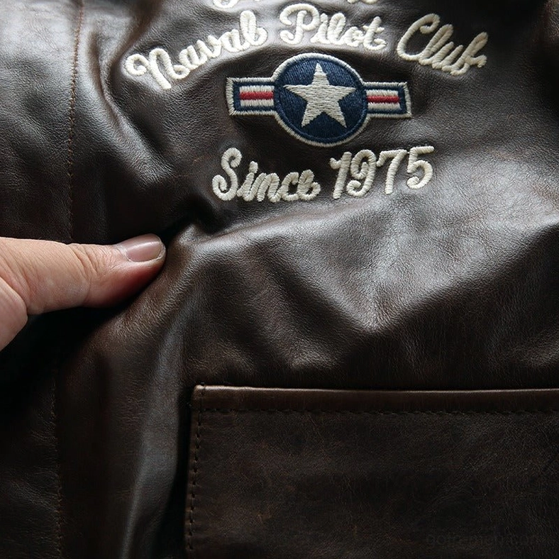 Front flap pocket and embroidery detail on men's gothic leather flight jacket in khaki tone