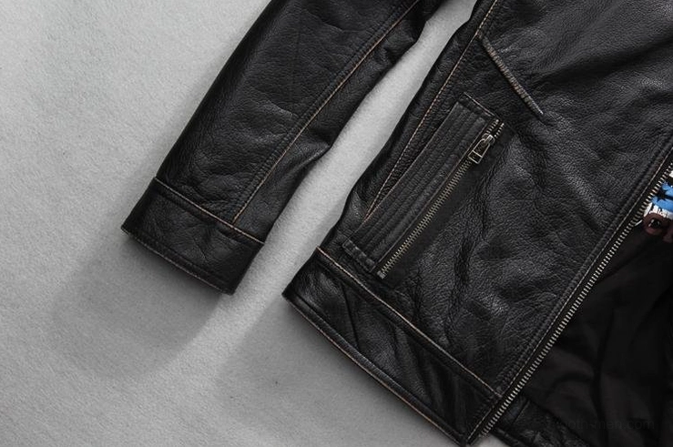 Black cowhide biker jacket body with vertical zipper pockets and adjustable cuffs