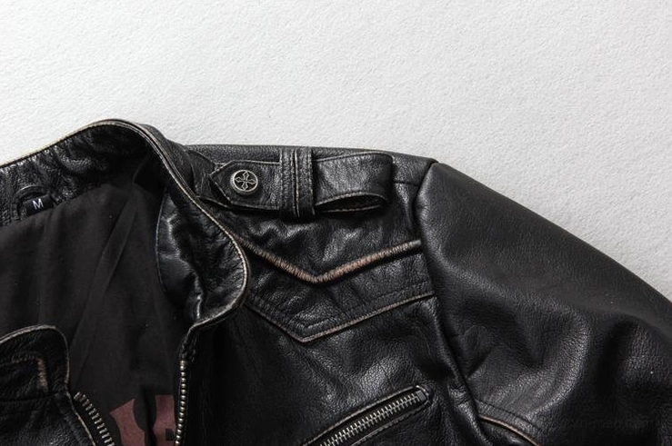 Black leather biker jacket shoulder epaulet and collar detail with contrast stitching