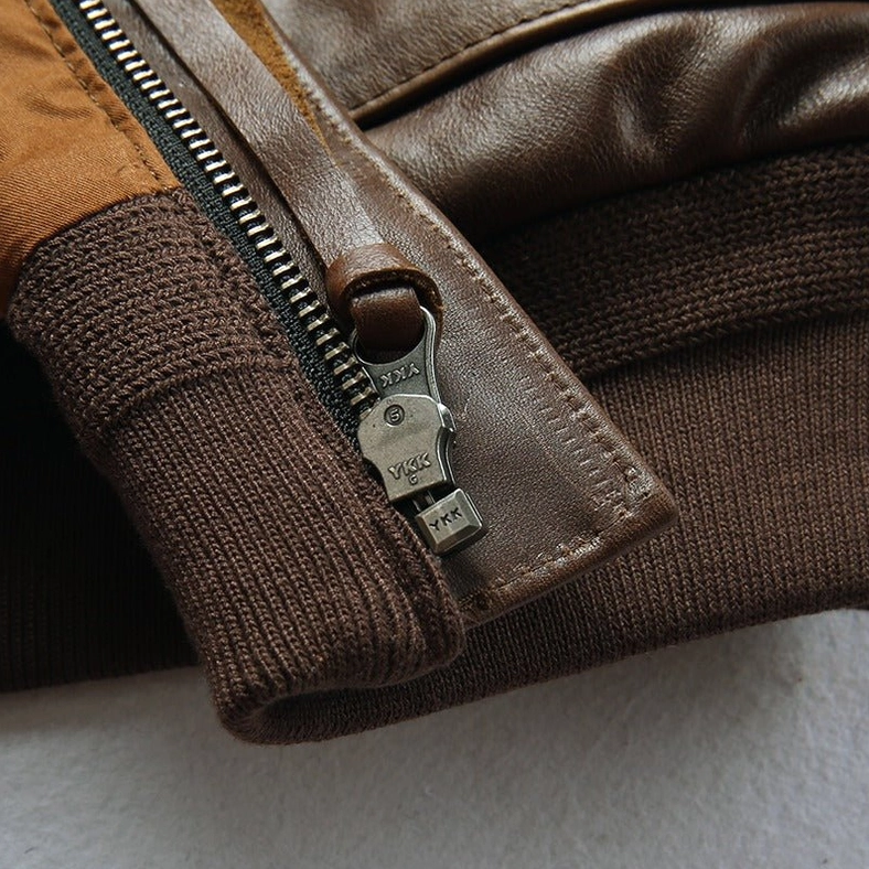 Detail shot of gothic leather jacket front zipper and pocket construction with embroidered accent