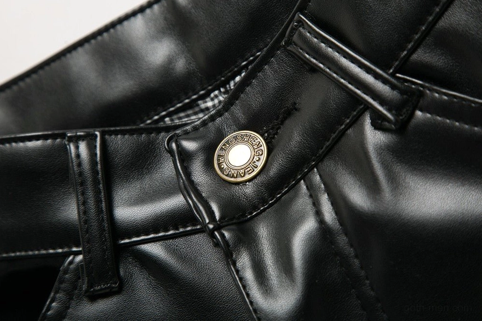 Front waistband detail featuring metal button, belt loops, and topstitching on dark PU leather pants