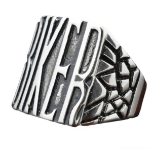 Tilted side view of gothic biker ring showing textured cracked side pattern and bold letter design in vintage silver tone