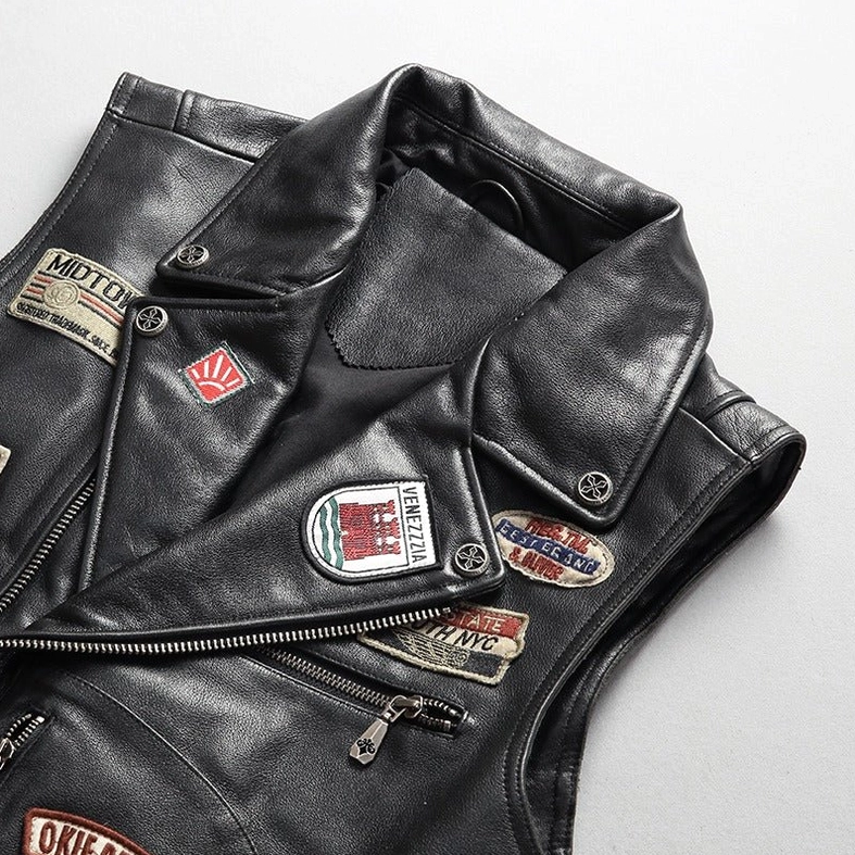 Close-up of gothic leather biker vest notched lapel collar and metal zipper hardware details