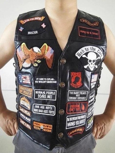 Male model wearing black gothic leather biker vest with skull and eagle patches casual daily style