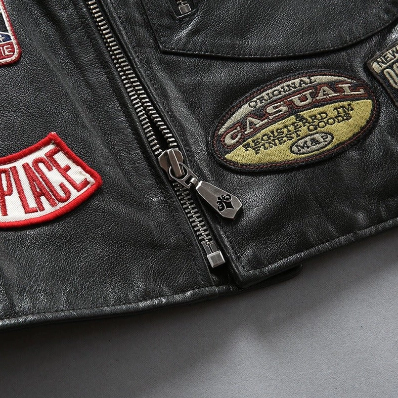 Extreme close-up of heavy-duty metal zipper and CASUAL embroidered patch on authentic cowhide biker vest